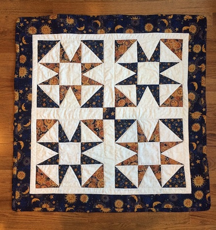 4 quilt squares with matching stars/moons/suns prints